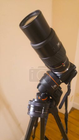Photo for Tarn, France - Feb. 2020 - A photographer's Japanese-made equipment, mounted on a stabilizer tripod : a Konica Minolta long focal length lens (teleobjective), fixed to a Sony Alpha NEX hybrid camera - Royalty Free Image