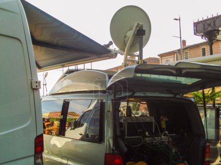Photo for Albi, France - May 4, 2017 - A television vehicle equipped with a parabolic antenna of a French news channels providing the media coverage of the then candidate Emmanuel Macron's election meeting - Royalty Free Image