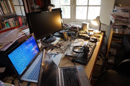 Photo for Albi, France - April 2020 - Desktop of an executive-engineer in remote working at home, equipped with computers, headphones and a webcam for telework, amid the coronavirus containment measures - Royalty Free Image