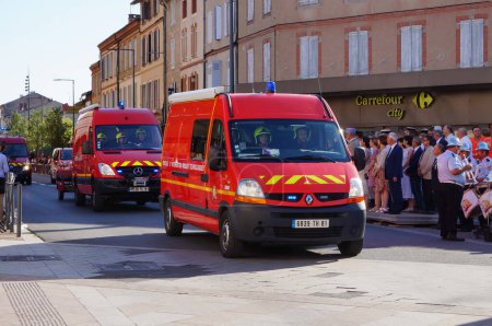 Photo for Albi, France - July 14, 2022 - Two red tank trucks for forest fire from the firefighting brigade of the Tarn (SDIS 81), take part to the National Day military parade on Charles de Gaulle Avenue - Royalty Free Image