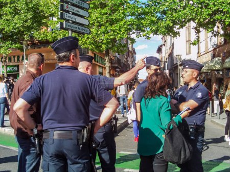 Photo for Albi, France - May 4, 2017 - Armed police officers of the French National Gendarmerie guiding passersby and talking with inhabitants, before the then candidate Emmanuel Macron's last election meeting - Royalty Free Image