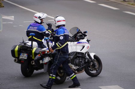 Photo for Albi, France - Sept. 2021 - A team of National Police officers by motorbike, at a roadblock, control the traffic on the street during a demonstration against the health pass and Covid-19 measures - Royalty Free Image