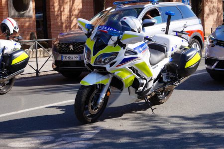Photo for Albi, France - July 14, 2022 - A white made-in-France Yamaha motorbike of the French "Police nationale", in front of two patrol vehicles, at the National Day ("Bastille Day") military parade - Royalty Free Image