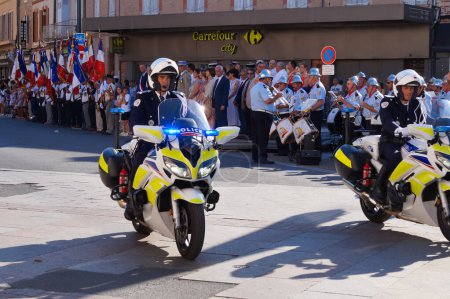 Photo for Toulouse, France - Feb. 2020 -  motorcyclists from a CRS unit of the French National Police, at a crosswalk in Jean Jaurs Square during a manifestation of Yellow Vests against the pension reform - Royalty Free Image