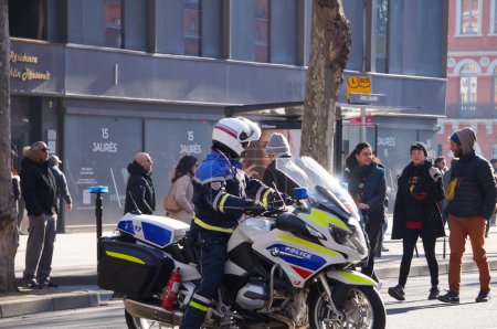 Photo for Toulouse, France - Feb. 2023 - French National Police's CRS (Republican Company of Security) motorcyclist, riding a BMW motorbike on Strasbourg Srasbourg, amid protests against the pension reform - Royalty Free Image