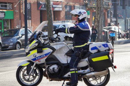 Photo for Toulouse, France - Feb. 2023 - French National Police's CRS (Republican Company of Security) motorcyclist, riding a BMW motorbike on Strasbourg Srasbourg, amid protests against the pension reform - Royalty Free Image