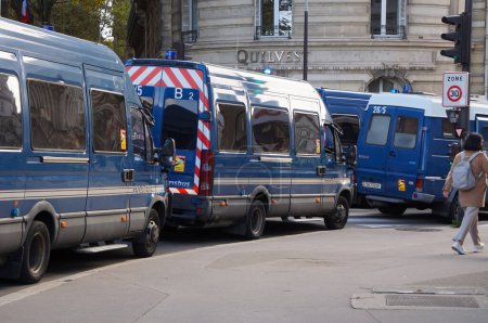 Photo for Paris, France - Oct. 10, 2020 - Convoy of blue minibuses of the "Gendarmerie mobile" (crowd control units of the French military police) in Rue de la Paix Street, near Marchons Enfants' manifestation - Royalty Free Image