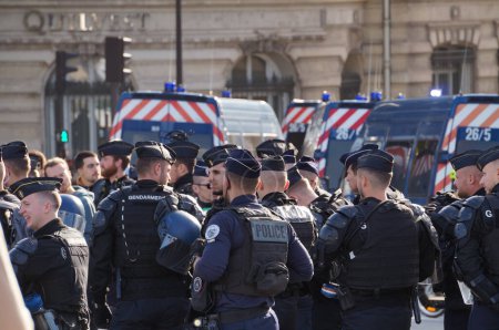 Photo for Paris, France - Nov. 2022 - A squadron of heavily equipped antiriot officers from the "Police nationale" and "Gendarmerie nationale", the French military police, in duty in front of Bourbon Palace - Royalty Free Image