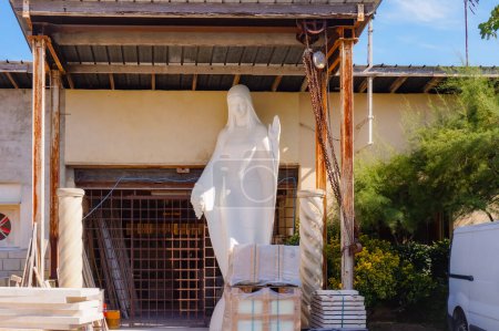 Photo for Saint-Andre-les-Vergers, France - Sept. 2020 - A white stone sculpture of the Blessed Virgin, under the awning of the workshop of stone-cutter Ludovic Pinguet - Royalty Free Image