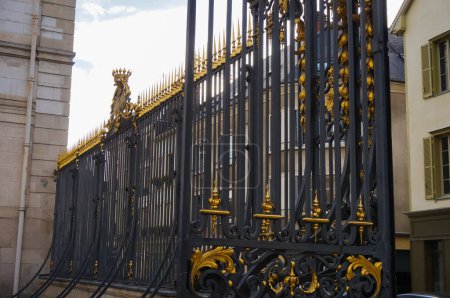 Photo for A 18th century cast iron gate, with gilded and forged metalwork, at the entrance of a former hospital founded by the Count of Champagne in the 12th century, the Htel-Dieu-Le-Comte, in Troyes, France - Royalty Free Image