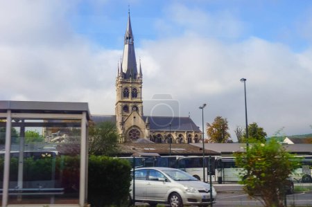 Photo for Epernay, France - Aug. 2020 - The bell tower of Notre-Dame's (Our Lady's) Church, a romanesque landmark, built in the 19th century, which dominates the town and is located in front of the bus station - Royalty Free Image