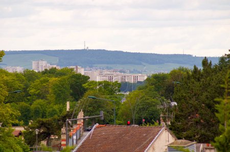 Photo for Reims, France - June 2021 - General view from the neighborhood of the Park of Champagne in the direction of Henri Vasnier Boulevard, towards the block towers of Croix-Rouge, below the mountain - Royalty Free Image