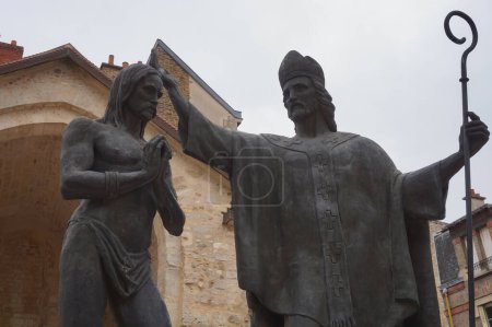 Foto de Reims, Francia - Abril 2021 - Estatua de bronce que representa el bautismo de Clovis, rey de los francos, por el obispo Saint-Remi; la obra de arte se realizó para celebrar el 1500 aniversario del evento - Imagen libre de derechos