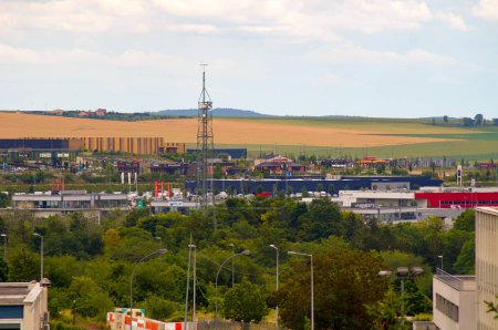 Téléchargez les photos : Reims, France - Juin 2021 - Vue panoramique sur le centre commercial et le parc d'affaires du Chemin Vert-Europe, dominé par l'antenne de contrôle de l'espace aérien, au pied du versant cultivé de la montagne de Reims - en image libre de droit