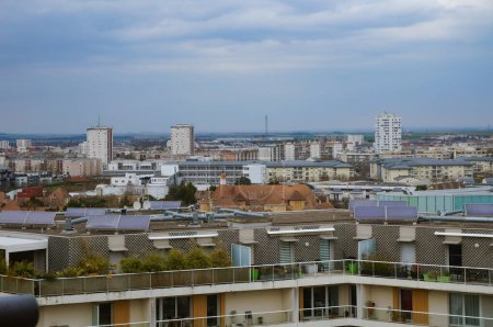 Photo for Reims, France - Sept. 2022 - Sweeping view over Europe, a popular district with social housing towers in the East of Reims, near the University of Science, with Chemin Vert Common House in the center - Royalty Free Image