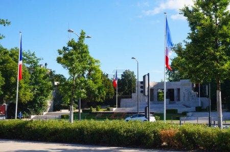 Foto de Reims, Francia - Mayo 2022 - Bandera de Francia junto al monumento de piedra a los muertos del memorial de guerra de Reims, erigido para ambas guerras mundiales, en la Plaza de Reims, frente a la Plaza de la República - Imagen libre de derechos