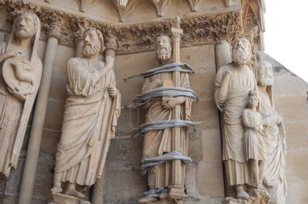 Photo for Rich statuary, sculpted from the 13th century, of Notre-Dame Cathedral of Reims, in France, by the entrance portal, featuring in particular the famous "Smiling Angel" (aka "the Smile of Reims") - Royalty Free Image