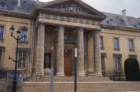 Photo for Reims, France - March 2021 - Outdoor staircase and colonnade at the entrance of the 19th century, Neo-Grec building of the Palace of Justice, which also features flags of France under the pediment - Royalty Free Image