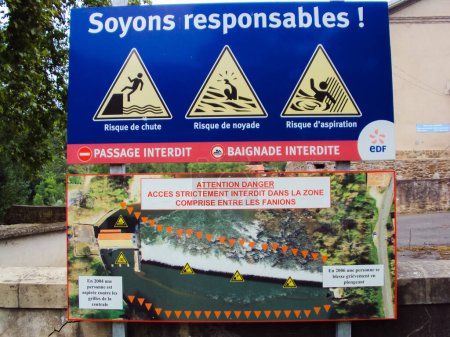 Photo for Les Avalats, France - Circa 2015 - Information board and warning signs near an EDF hydroelectric dam, cautioning against drowning, aspiration or fall hazards and abrupt changes in water level - Royalty Free Image