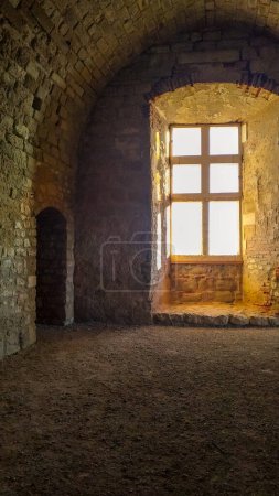 Photo for Inside the ruins of the castle of Castelnau-de-Lvis, Southern France : medieval muntin window in the vaulted main room of the lordly house - Royalty Free Image