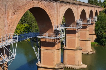 Photo for Metal framework overhanging above the water of the River Tarn, at the construction site of the future gangway of Albi, France, built under the arches of an older railway viaduct, in Jan. 2021 - Royalty Free Image