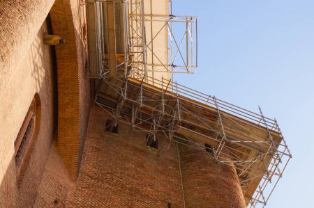 Photo for Low-angle view of the scaffolding set up at height against the top of the Sainte-Catherine's Tower of the Episcopal Berbie Palace, in Albi, France, for restoration works of heritage protection - Royalty Free Image