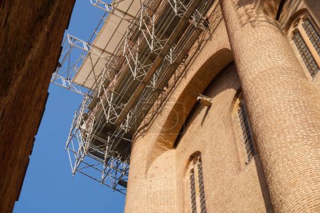 Photo for Low-angle view of the scaffolding set up at height against the top of the Sainte-Catherine's Tower of the Episcopal Berbie Palace, in Albi, France, for restoration works of heritage protection - Royalty Free Image