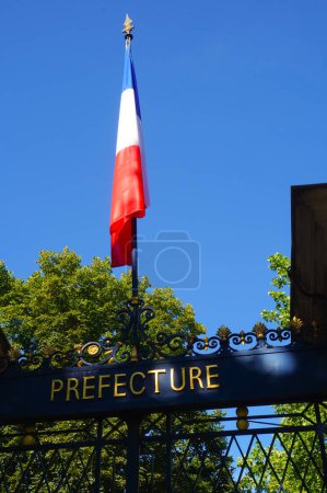 Téléchargez les photos : Le drapeau national français sur son poteau, au-dessus de la porte du jardin de la Préfecture du Tarn, à Albi, France - en image libre de droit