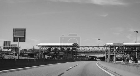 Photo for Lyon, France - June 2019 - Toll barrier on the Boulevard Priphrique (ring road of Lyon) and concrete bridge at the entrance of the urban tunnel of Caluire, which passes under the River Saone - Royalty Free Image