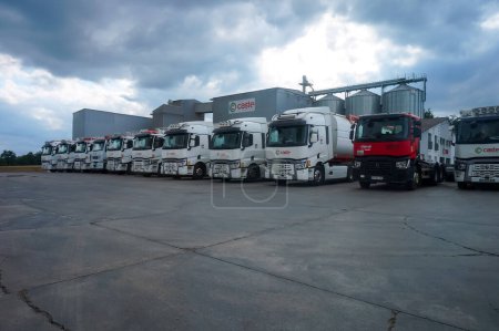 Photo for Mirandol-Bourgnounac, France - Sept. 2021 - Fleet of several semi-trailer trucks, side by side, in front of the grain silos of Caste Aliment, a producer of animal feed in the area of Carmaux - Royalty Free Image