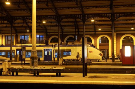 Photo for Toulouse, France - Jan. 2020 - Night view in Toulouse-Matabiau railway station and a REGIOLIS railcar at the platform operated by SNCF on TER (Regional Express Train) lines and manufactures by Alstom - Royalty Free Image