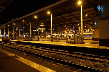 Photo for Toulouse, France - Jan. 2020 - Night view of the tracks and platforms of Toulouse-Matabiau train station, with railcars operated by SNCF on the TER (Regional Express Train) network in the background - Royalty Free Image