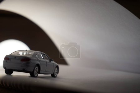 Photo for Scale model of a sedan car in a white neutral futuristic backround, with white light and clair-obscur effect - Royalty Free Image