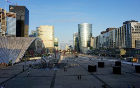 Photo for La Defense, France - July 1, 2019 - The Esplanade de la Defense, huge pedestrian area in the middle of Paris Central Business District, lined with the CNIT, towers and skyscrapers, seen from the Arch - Royalty Free Image