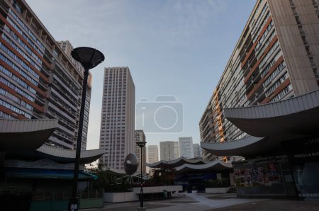 Photo for Paris, France - April 2022 - The Olympiades Esplanade, in the 13th arrondissement's Chinatown, with the Asian pointy roofs of the Mercure mall in the centre, bordered with residential high-rise tower - Royalty Free Image