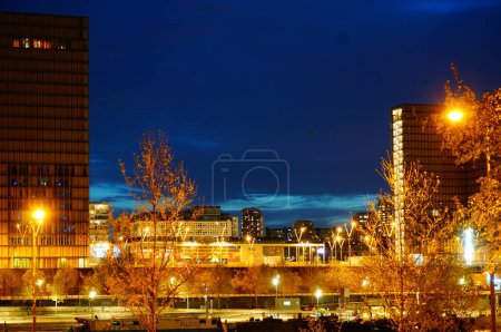 Photo for Paris, France - April 2022 - Night view in the dark of the illuminated towers of Francois Mitterrand French National Library (BNF), on Quai Mauriac, in the neighborhood of Bercy (12th arrondissement) - Royalty Free Image