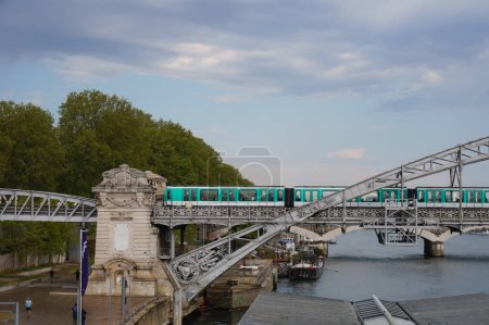Foto de París, Francia - Mayo 2021 - Un tren pasa por el viaducto de Austerlitz, un puente de proa con cubierta suspendida construido en 1904, que soporta una sección elevada de la quinta línea de metro, cruzando el río Sena - Imagen libre de derechos