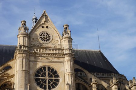 Photo for Detail of the transept of Saint-Eustache's Church, a 17th century, Gothic and Renaissance landmark in the Quartier des Halles, in Paris, France ; the tower features a rose window and a sundial - Royalty Free Image