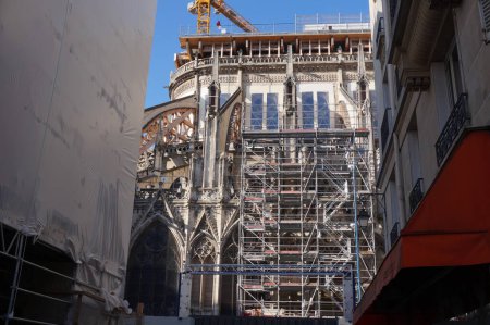 Photo for Paris, France - April 24, 2021 - Reconstruction site of the medieval Notre-Dame Cathedral, damaged by a fire in 2019 : here, the apse of the gothic building is flanked with huge scaffoldings - Royalty Free Image