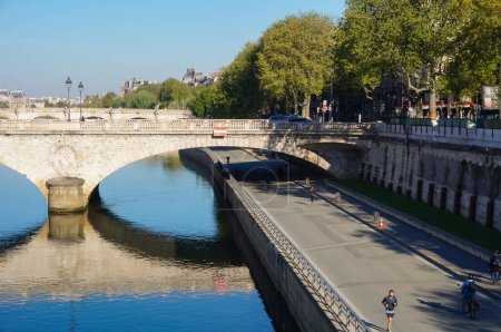 Photo for Paris, France - April 2021 - Passing under the bridge Pont au Change, a pedestrianized embankment road by the River Seine, below the dike, in Paris IV ; the promenade is quiet in the morning - Royalty Free Image