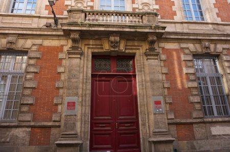 Photo for Ile de la Cite, Paris, France - April 2021 - Red brick facade on Chanoinesse Street of the romantic-style building of the National School for Magistrates (ENM, "Ecole Nationale de la Magistrature") - Royalty Free Image