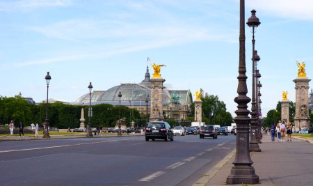 Photo for Paris, France - July 2019 - The Avenue Winston Churchill, bordered with golden-statues-topped columns, and the Grand Palais with its huge canopy (biggest glass roof in Europe) - Royalty Free Image