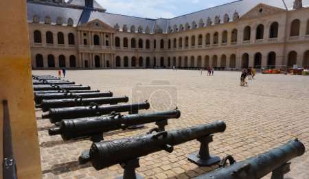 Photo for Paris, France - July 2019 - Series of bronze sculpted and decorated old cannon barrels, aligned in the main courtyard of the Hotel National des Invalides (Army Museum) and exhibited for the public - Royalty Free Image