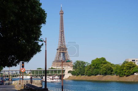 Photo for Paris, France - June 2019 - Panoramic view of Paris' skyline, dominated by the Eiffel Tower ; the perspective of Ina Bridge heads to the Military School (cole Militaire) via Champ de Mars Park - Royalty Free Image