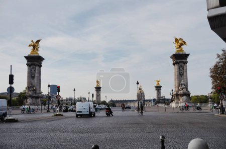 Photo for Paris, France - Sept. 2022 - Columns topped with gilded sculptures at the end of Alexandre III Bridge (8th district) at the junction of Quai d'Orsay and Winston Churchill, which leads to the Invalides - Royalty Free Image