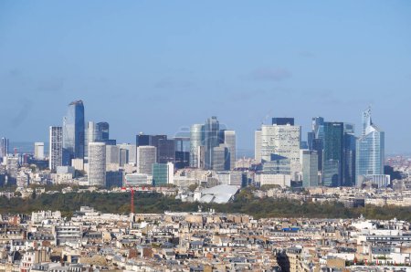 Photo for Paris, France - Nov. 2022 - Seen from the Eiffel Tower, beyond the capital's 16th arrondissement, the modern skyline of La Defense, Europe's largest financial district, composed of glass skyscrapers - Royalty Free Image