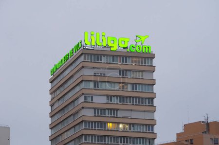 Photo for Paris, France - Dec. 4, 2022 - A residentiel or office building in Porte de Versailles, topped with an advertising, illuminated sign for Liligo.com, a metasearch engine and price comparator for travel - Royalty Free Image