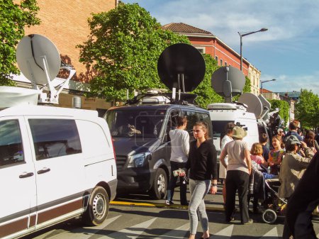 Photo for Albi, France - May 4, 2017 - Television vehicles of the main French news channels, equipped with satellite dishes, providing the media coverage of the then candidate Emmanuel Macron's election meeting - Royalty Free Image