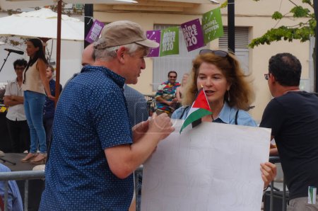 Foto de Toulouse, Francia - 25 de junio de 2020 - Un activista antisionista con bandera de Palestina y un letrero que dice "Libertad de expresión para BDS", conversa con un hombre en una reunión electoral del ecologista Antoine Maurice - Imagen libre de derechos