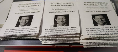 Photo for Occitanie, France - May 2019 - Piles of pamphlets with the political statements of Francois-Xavier Bellamy, young conservative candidate for the European election and deputy mayor of Versailles - Royalty Free Image